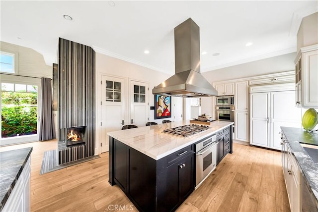 kitchen featuring a center island, built in appliances, light hardwood / wood-style floors, island range hood, and white cabinets