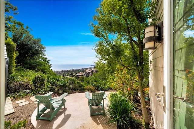 view of patio with a water view