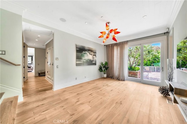 interior space with light wood-type flooring, crown molding, and a chandelier