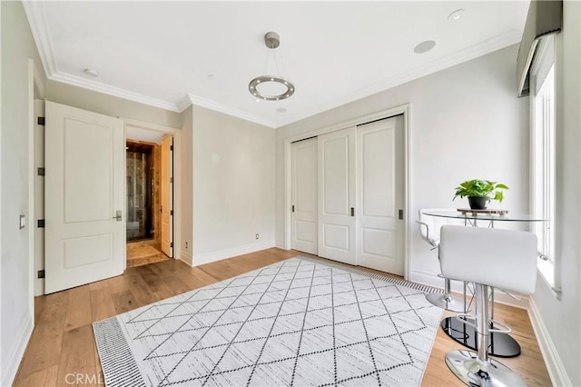 unfurnished bedroom featuring multiple windows, a closet, ornamental molding, and light wood-type flooring