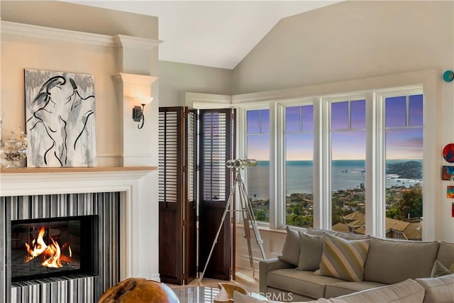 living room with a water view and vaulted ceiling