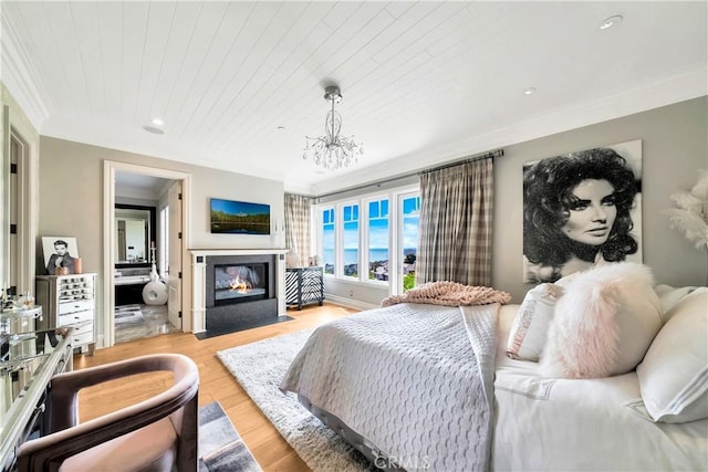 bedroom with light wood-type flooring, wooden ceiling, and a notable chandelier