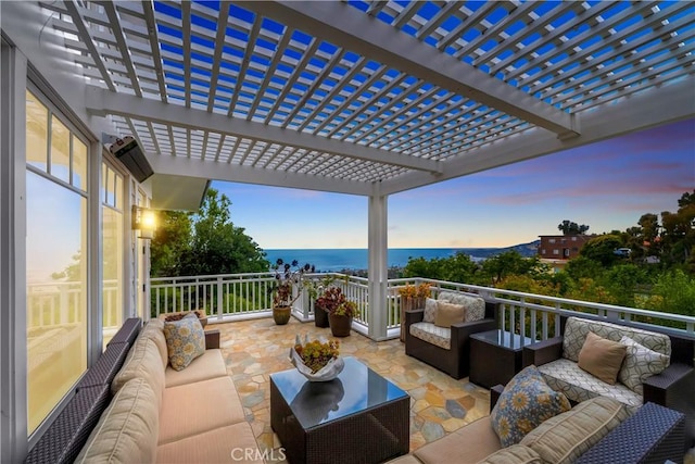 patio terrace at dusk featuring an outdoor living space and a water view