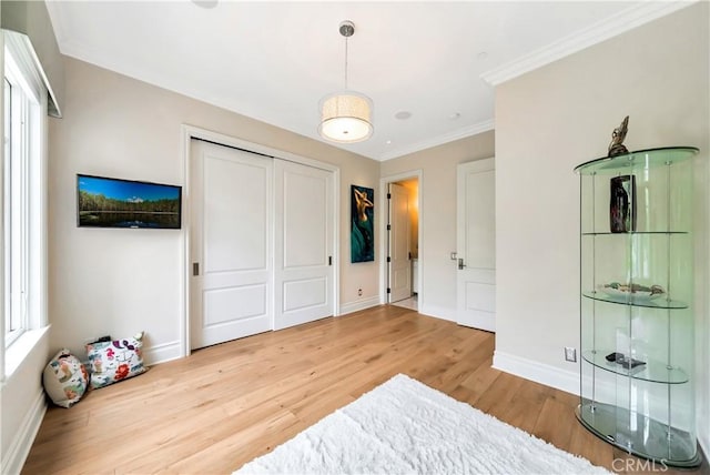 bedroom featuring hardwood / wood-style flooring, a closet, and ornamental molding