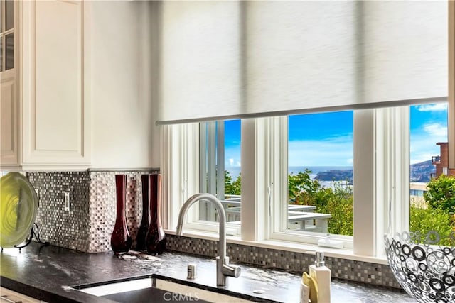 interior space with decorative backsplash and sink