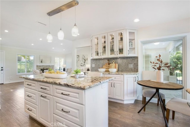 kitchen with tasteful backsplash, white cabinetry, and dark hardwood / wood-style floors