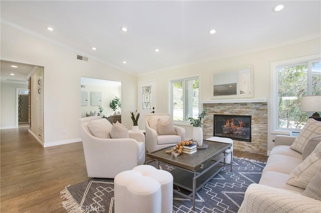 living room with dark hardwood / wood-style flooring, lofted ceiling, a fireplace, and ornamental molding