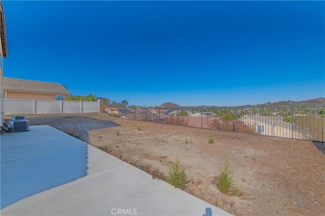 view of yard with a patio area, a mountain view, and central AC