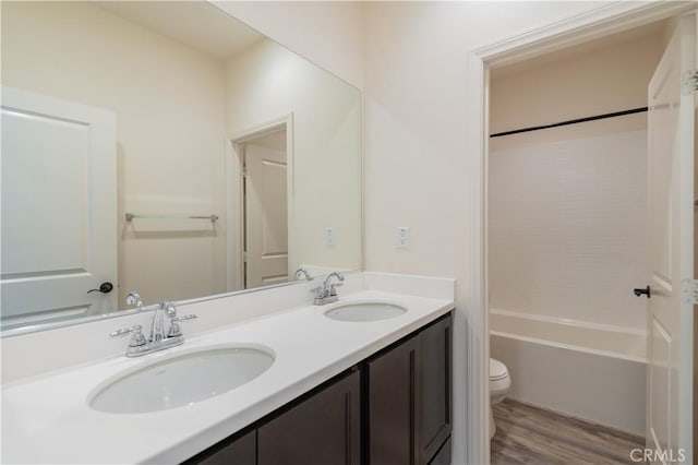 full bathroom featuring toilet, vanity, shower / bath combination, and hardwood / wood-style flooring