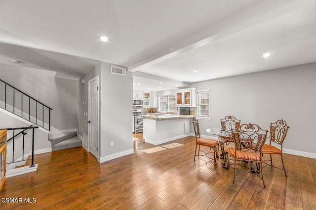 dining space with hardwood / wood-style floors