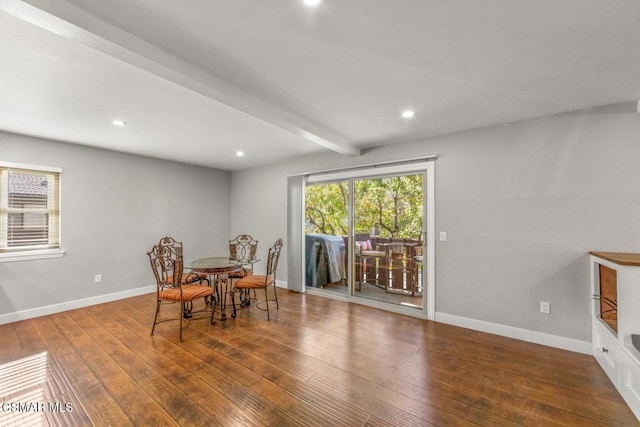 dining area with beam ceiling and hardwood / wood-style flooring