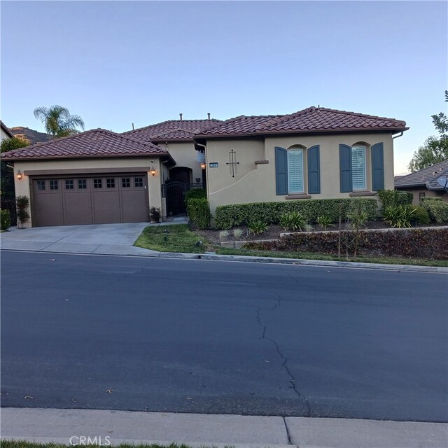 mediterranean / spanish-style house with a garage