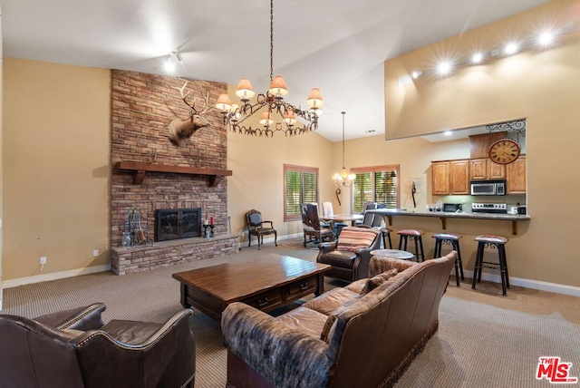 living room with a chandelier, light colored carpet, high vaulted ceiling, and a fireplace