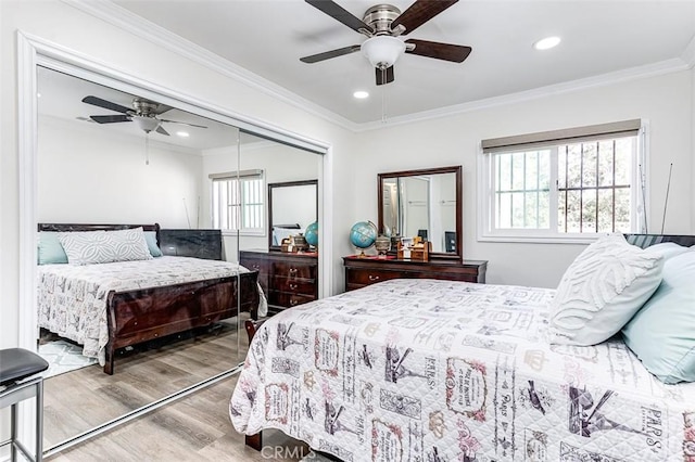 bedroom featuring multiple windows, ceiling fan, and a closet