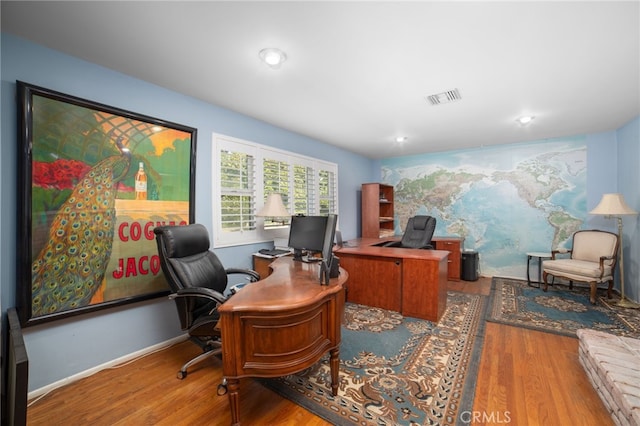 office space with wood-type flooring