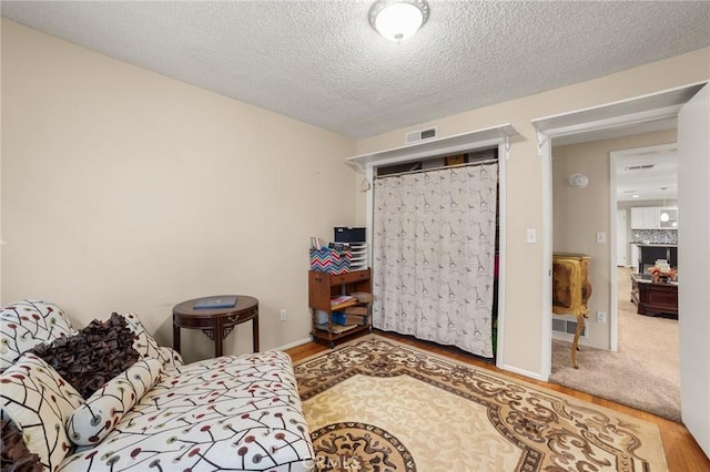 bedroom featuring hardwood / wood-style flooring and a textured ceiling