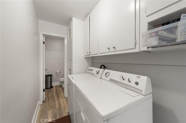 laundry area featuring washing machine and dryer and hardwood / wood-style flooring