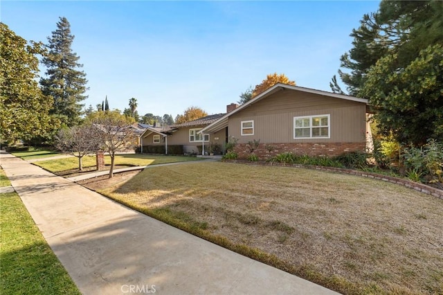 ranch-style home featuring a front yard