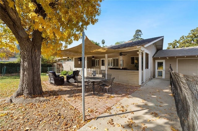 back of property with ceiling fan and a patio area