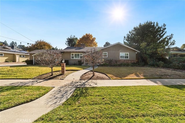 single story home with a front lawn