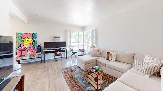 living room featuring a wall mounted AC and hardwood / wood-style floors