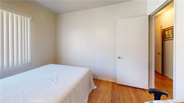 bedroom featuring light hardwood / wood-style floors and multiple windows