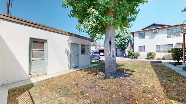 view of yard with a wall mounted AC