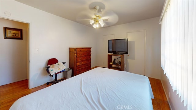 bedroom featuring hardwood / wood-style flooring and ceiling fan