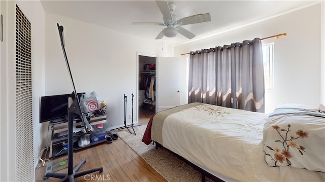 bedroom featuring ceiling fan, a closet, and hardwood / wood-style flooring