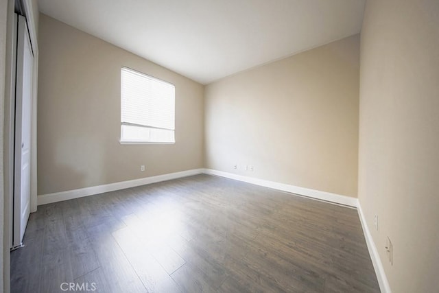 spare room with dark hardwood / wood-style flooring