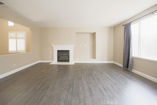 unfurnished living room with dark hardwood / wood-style flooring