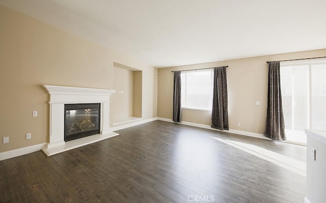 unfurnished living room featuring dark hardwood / wood-style flooring