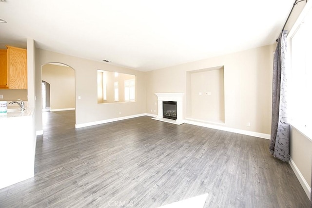 unfurnished living room featuring dark hardwood / wood-style floors