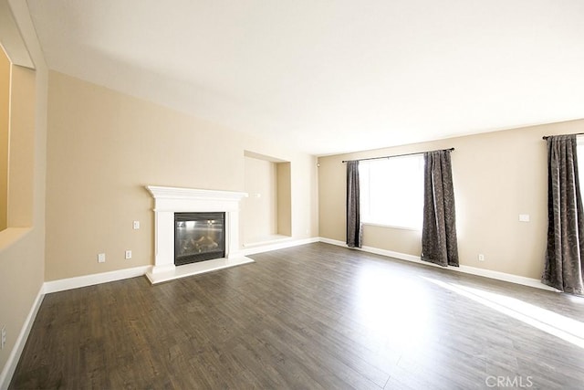 unfurnished living room with dark hardwood / wood-style floors