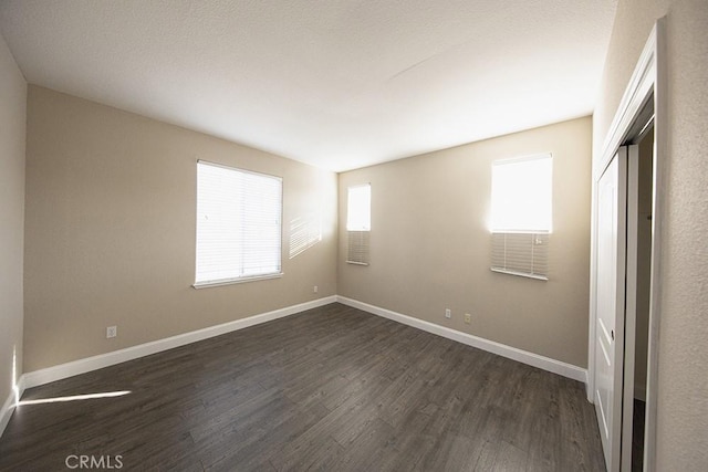 interior space with dark hardwood / wood-style floors and a closet