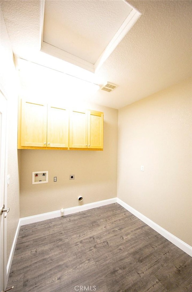 laundry room featuring cabinets, washer hookup, a textured ceiling, and dark hardwood / wood-style floors