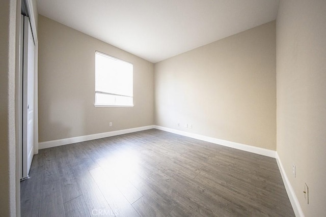 spare room featuring dark wood-type flooring