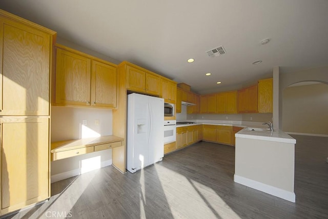 kitchen featuring light brown cabinets, dark hardwood / wood-style floors, white appliances, and sink