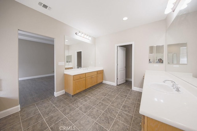 bathroom featuring tile patterned flooring and vanity