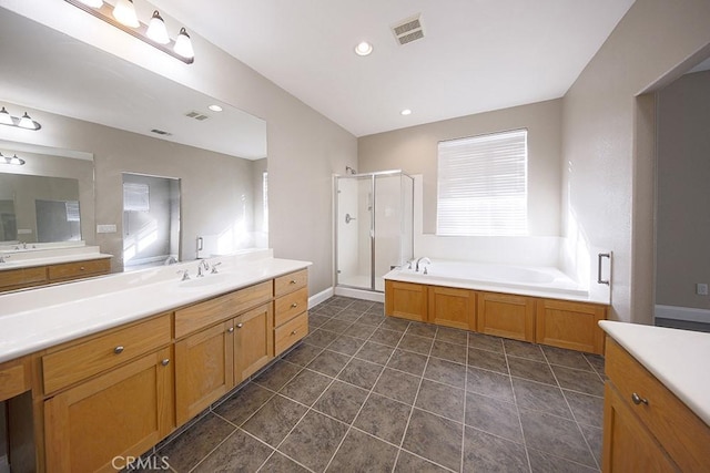 bathroom with separate shower and tub, a wealth of natural light, tile patterned flooring, and vanity