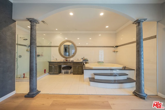 bathroom featuring vanity, ornate columns, hardwood / wood-style flooring, crown molding, and plus walk in shower