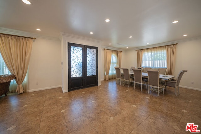 dining room featuring french doors and crown molding