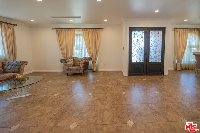 foyer with ornamental molding and french doors