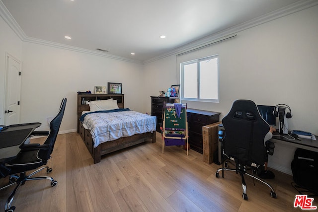 bedroom with crown molding and light hardwood / wood-style flooring