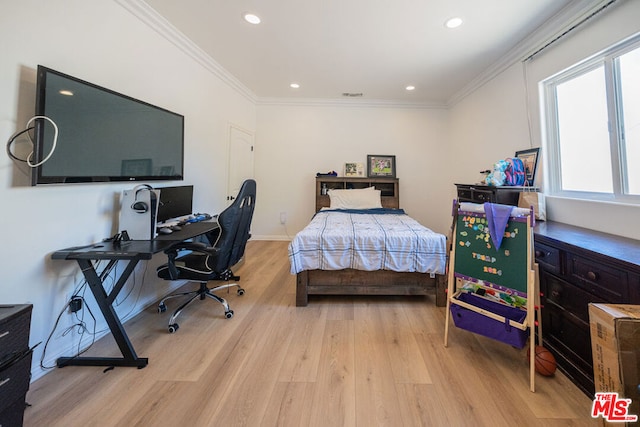 bedroom featuring crown molding and light wood-type flooring