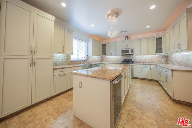 kitchen featuring stainless steel range, wine cooler, light stone countertops, a kitchen island, and sink