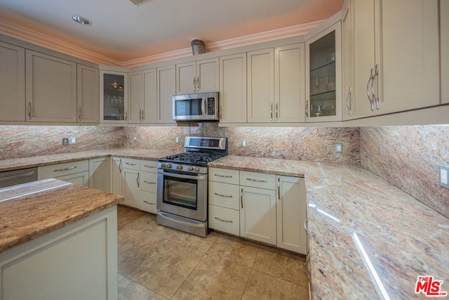 kitchen featuring backsplash, light stone countertops, crown molding, and stainless steel appliances