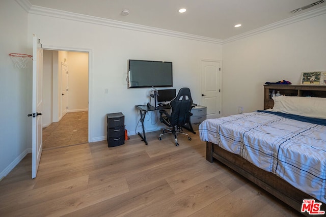 bedroom featuring ornamental molding and light hardwood / wood-style floors