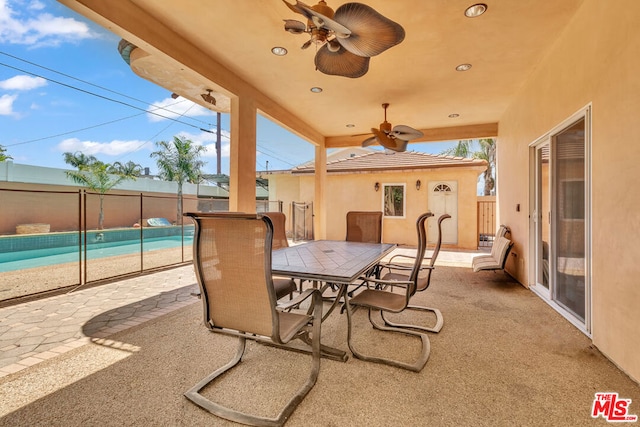 view of patio with ceiling fan and a fenced in pool