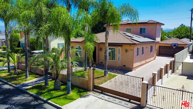 view of front of house with solar panels and a garage